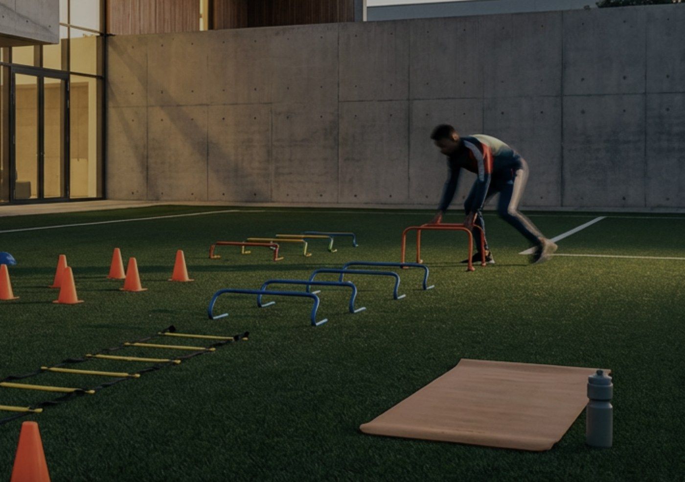 A player working through agility hurdles on a training pitch